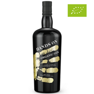 DAVID GÖLLES HANDS ON Organic Gin in schwarzer Flasche mit goldenem Handabdruck und Bio-Logo.