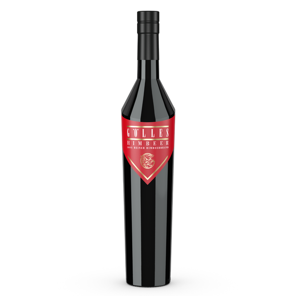 Gölles Himbeerbrand in hoher schwarzer Flasche mit spitzem rotem Etikett und rundem Emblem.