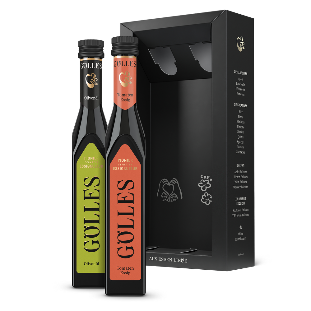 Gölles Duo Mediterran: Olivenöl und Tomaten Essig neben offener schwarzer Geschenkbox.