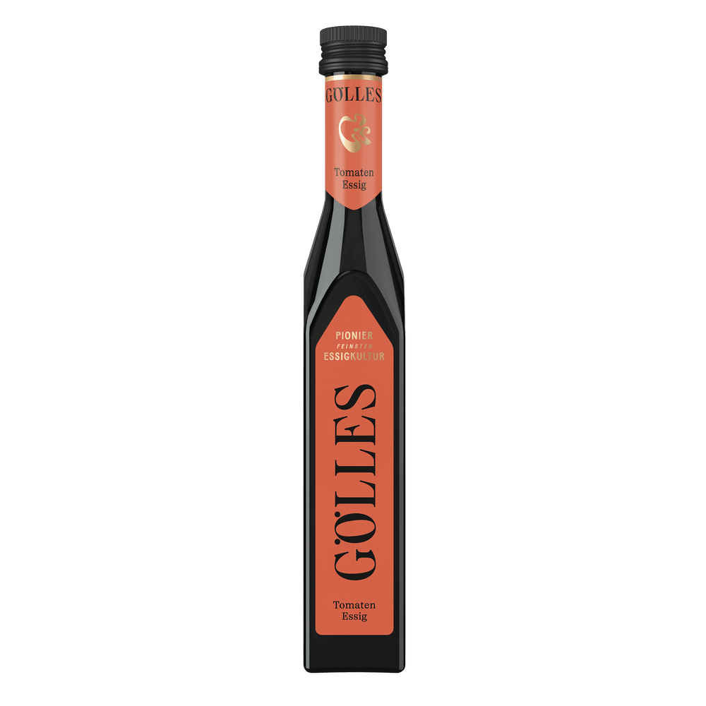 Gölles Tomaten Essig in hoher eckiger Flasche mit orangefarbenem Etikett und schwarzem Verschluss.