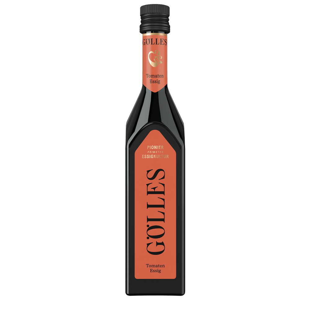 Gölles Tomaten Essig in hoher eckiger Flasche mit orangefarbenem Etikett und schwarzem Verschluss.