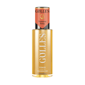 Gölles Tomaten Essig, goldgelb, in Glasflasche mit rotem Etikett.