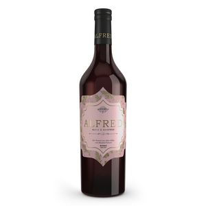 Gölles Wermut Alfred Rosso in Flasche mit rosa Etikett, goldener Schrift und floralem Muster.