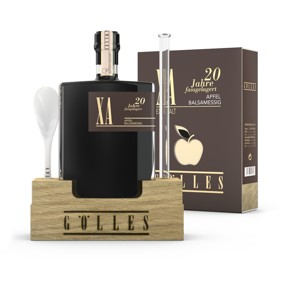 Gölles XA Apfel Balsamessig in eckiger Flasche im Holzständer mit Porzellanlöffel, Pipette und Schachtel.